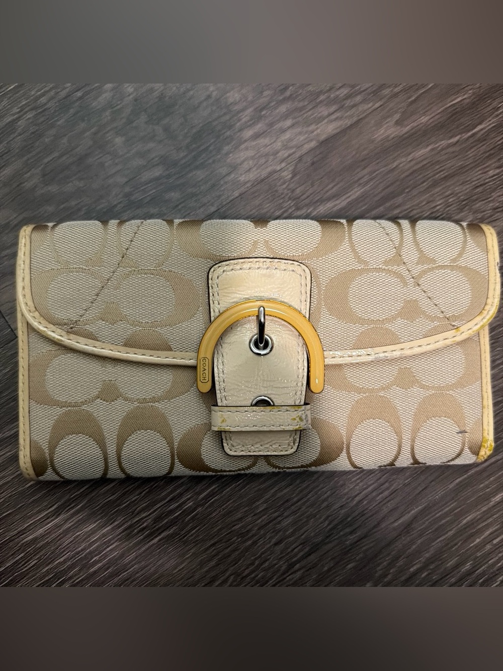 Coach beige and cream wallet with repeating beige C logo pattern